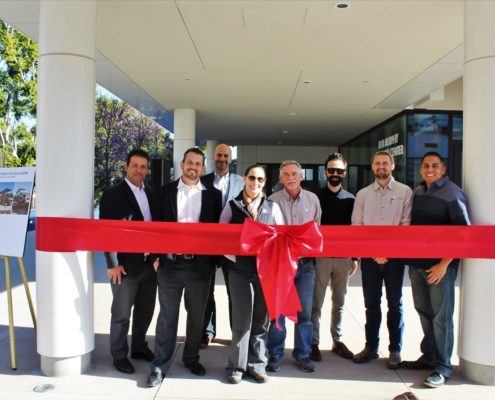 Team stands in front of ribbon at CSULB Student Success Center grand opening