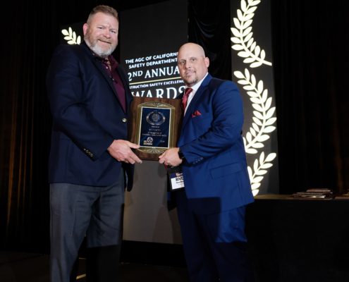 Swinerton holding plaque at the AGC of CA Safety Excellence Awards