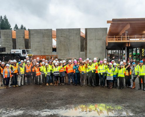 Group of people smiling at topping out event