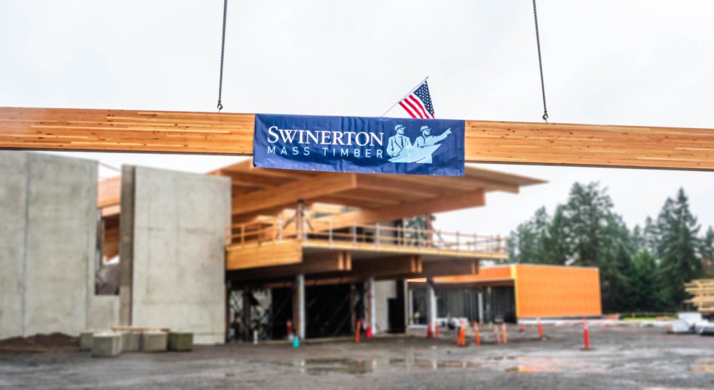 Swinerton Mass Timber banner on beam; topping out Hillsboro community center