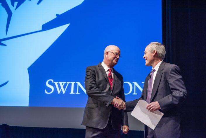 Jeff-Hoopes-Eric-Foster-Swinerton Former Swinerton CEO Jeff Hoopes (left) shakes hands with new CEO Eric Foster..