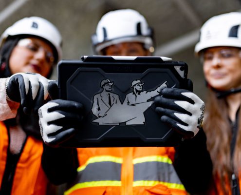 Women in construction holding construction technology innovation ipad
