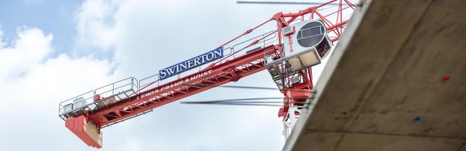 Swinerton tower crane over a concrete building under construction