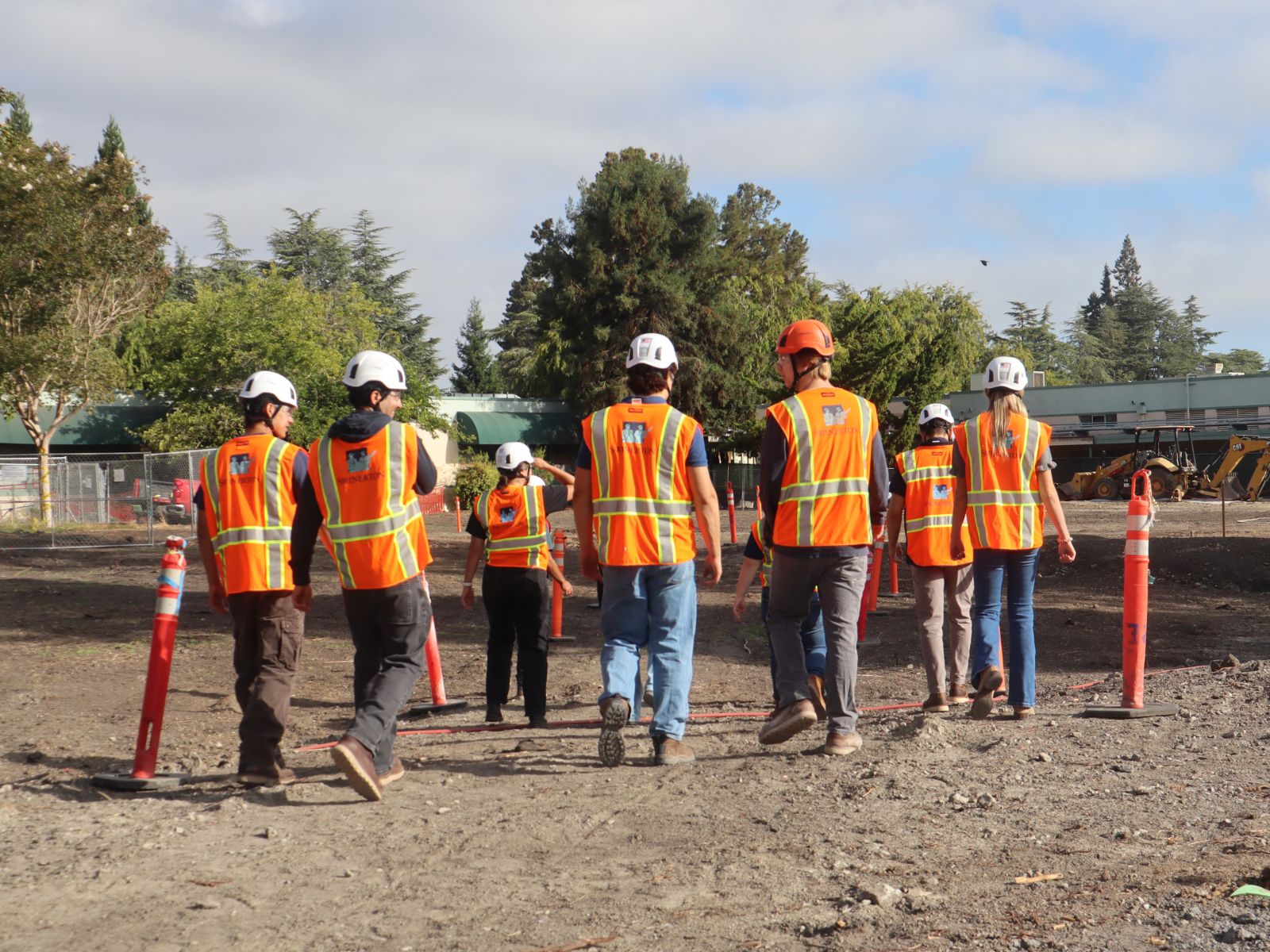 Swinerton intern walking an active construction site with an experienced team member